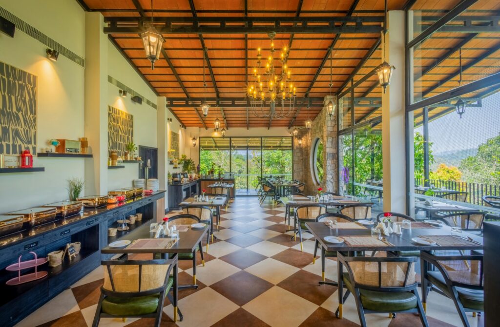 Spacious restaurant with stylish decor and large windows showcasing a scenic view.